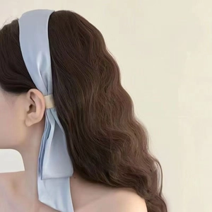 Elegant light blue satin headband with long ribbon and gold metal buckle on female model