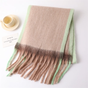 Close-up of beige and mint green plaid scarf with soft fringe and French quote card