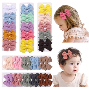 Set of 10 solid color waffle texture bow hair clips for toddlers and girls