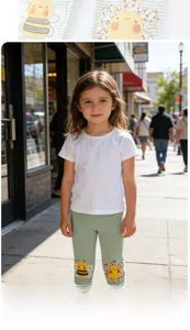 Close-up of green and white striped girls leggings with cute bee and flower knee patches