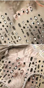 Detail of star and python pattern nail stickers with trendy black and white designs