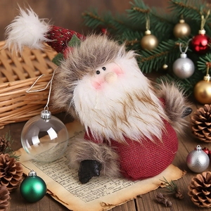 Christmas Santa plush doll with knitted red hat and burlap body on festive background