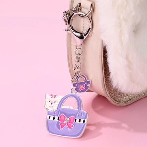 Detailed close-up of a purple crown puppy bag charm with sparkling alloy crystals