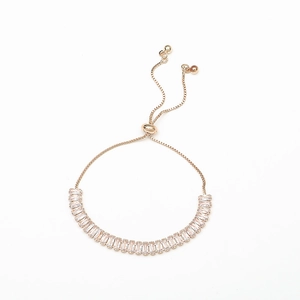 Close-up of rose gold adjustable bracelet featuring rectangular clear zircon stones