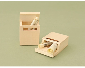 Detail view of miniature wooden mailboxes with rolled paper inserts for dollhouse decor