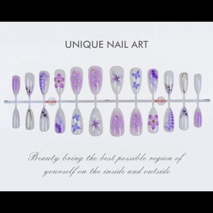 Macro view of purple 3D flower and butterfly press-on nails with golden star details