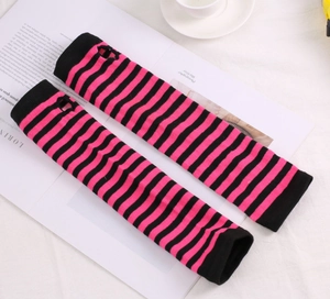 Detail of Y2K style black and pink striped knit arm warmers with thumb holes on magazine