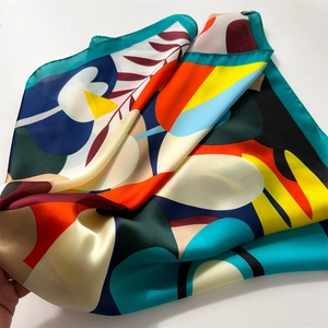 Detailed close-up of vibrant floral printed square scarf with satin finish texture