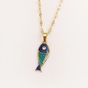 Close-up of golden fish pendant with blue and turquoise enamel and sparkling rhinestone eye