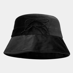 Detailed close-up of velvet texture and twin bow accents on black bucket hat