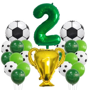 Detail of soccer party set with number 2 balloon, golden champion trophy and latex balloons