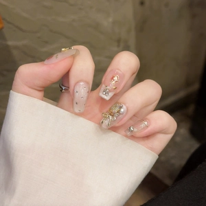 Handmade press-on nails with pink cat eye base, 3D golden roses, and pearl accents