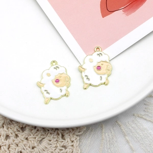 Detail of cute white sheep alloy pendant with gold plating and enamel finish