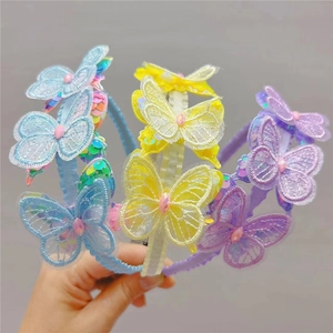 Detail of embroidered lace butterfly headbands with colorful sequins in three colors