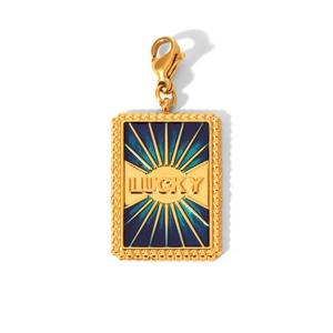 Detail of a golden pendant featuring blue enamel with LUCKY text and a lobster clasp