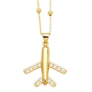 Minimalist gold airplane pendant necklace with zircon wings on a beaded chain