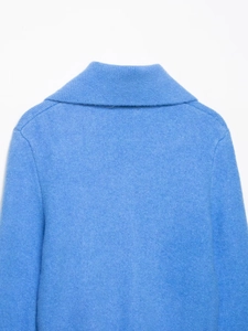 Detail view of royal blue knit sweater with wide lapel collar and dropped shoulder seams