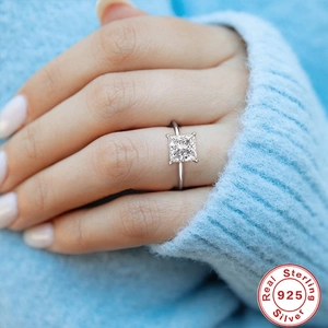 Close-up of model wearing a luxury square cut diamond 925 silver ring on hand