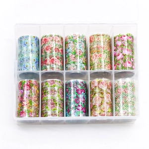 10 rolls of floral nail art transfer foils with rose patterns in a clear plastic storage box