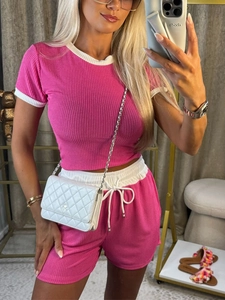 Pink knit two-piece set with short sleeve top and matching shorts in elegant style