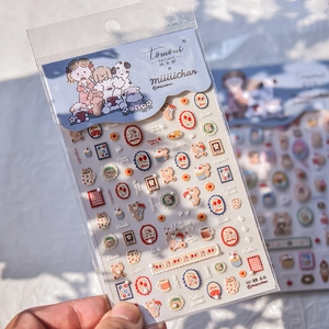 Macro shot of 3D bear and girl nail art stickers with sparkling crystal diamond details