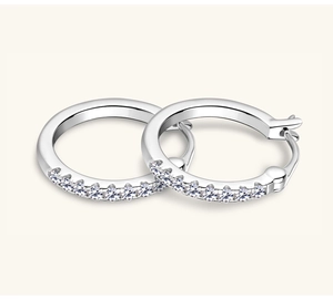 Detail view of silver S925 sterling silver hoop earrings with row-set white Moissanite stones
