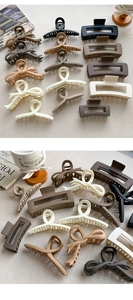 Collection of matte hair claws in neutral tones and various geometric shapes on linen cloth