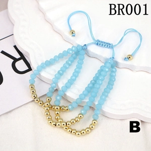 Set of four adjustable light blue and gold beaded bracelets with braided cords