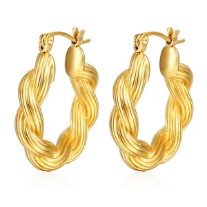 Macro detail of high-polish twisted rope hoop earrings with 18k gold plating finish