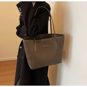 Detail of dark grey woven tote bag with long shoulder straps for office commute