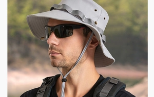 Detail view of wide-brim sun hat with breathable side vents and adjustable chin cord