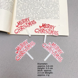 Detail of red Merry Christmas cake toppers with dimensions shown on a gray surface