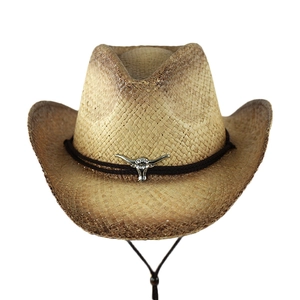 Detail of raffia cowboy hat with raw edges and silver longhorn bull metallic ornament