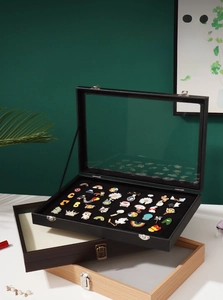 Close-up of vintage wooden badge display case with velvet lining and transparent cover