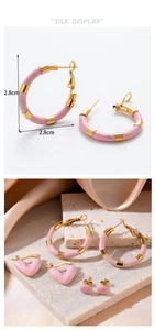 Detailed view of 2.8cm pink C-shaped earrings on stone tray with champagne satin