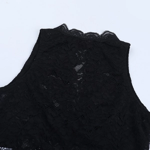 Close-up of intricate floral lace texture and neckline detail on a black sheer top