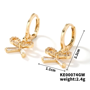 Detailed view of gold bow earrings with cubic zirconia, dimensions 2.2cm by 1.1cm