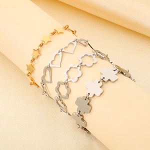 Detail of four-piece set with gold star and silver hollow heart and clover bracelets