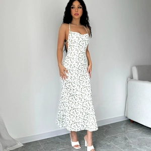 Detailed back view of a floral halter dress showing the sexy backless design and slit