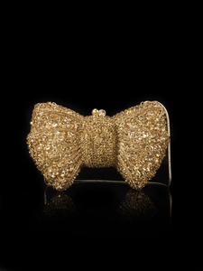 Detailed macro view of champagne crystal bow clutch bag with luxury diamond chains