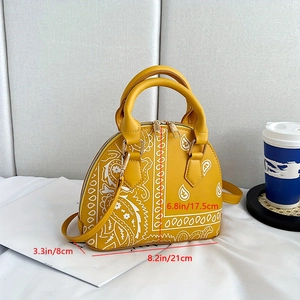 Detail view of yellow paisley shell bag showing dimensions 21x17.5x8cm with top handle