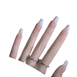 Handmade glow-in-the-dark long coffin nails with white flame patterns over nude base