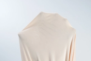 Detailed close-up showing the elastic pink knitted fabric with breathable micro-texture