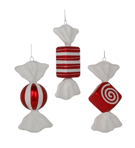 Detailed view of red and white striped Christmas candy ornaments with glitter finish