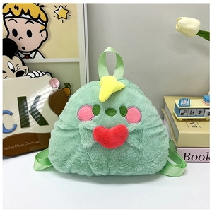 Close-up of green plush backpack with yellow horns, red heart, and soft adjustable straps