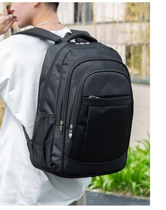 Outdoor shot of the ergonomic black business backpack worn by a model in nature