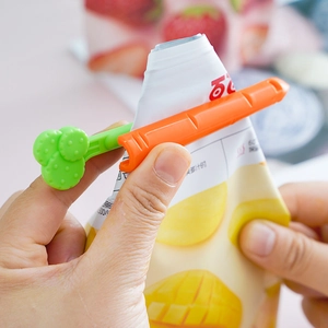 Carrot-shaped food bag sealing clips in vibrant orange and green for kitchen storage