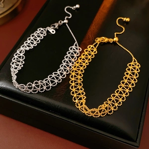 Detailed close-up of gold and silver plated woven geometric bracelets on a jewelry box