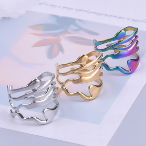Detailed view of hollow irregular rings in gold, silver, and iridescent steel finishes