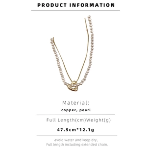 Detailed view of layered necklace specifications showing pearl beads and heart pendant